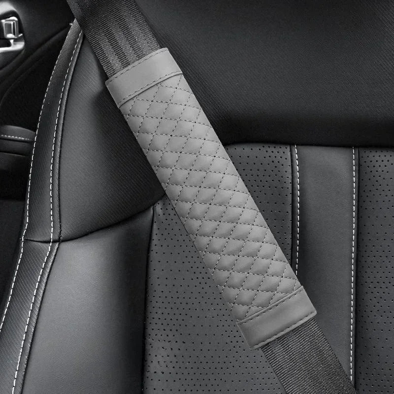 Gray quilted car seat belt cover on a car seat
