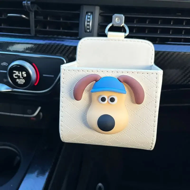 a dog car organizer with a blue bandana hanging from a car's air vent.