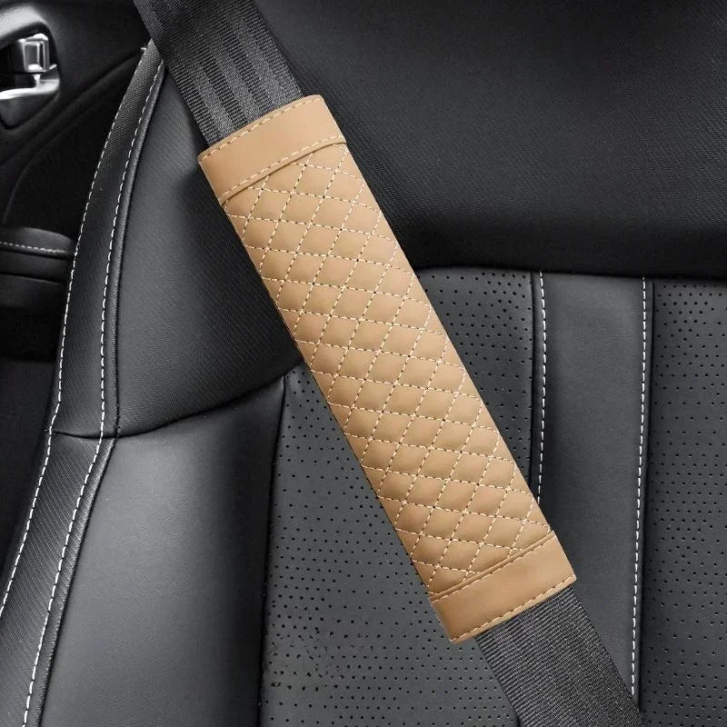 Beige quilted car seat belt cover on a car seat