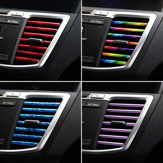 Car air vent cover with colorful stripes in red, blue, green, and purple.