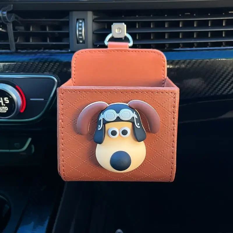 Car air freshener with a cartoon dog design attached to a car's air vent.