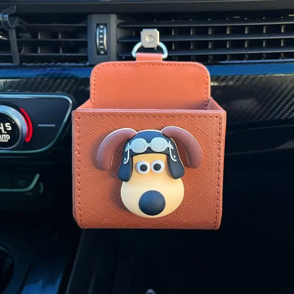 Car air freshener with a cartoon dog design attached to a car's air vent.