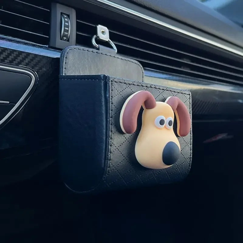 Car bag shaped like a dog hanging from a car's air vent.