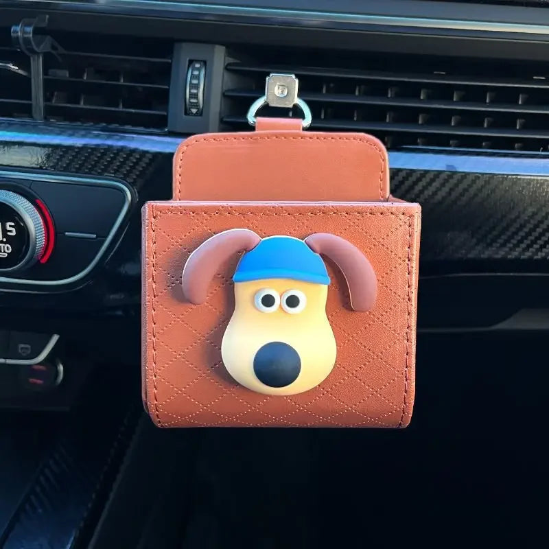 Car bag with a cartoon dog design attached to a car's air vent.