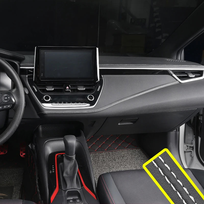 Car interior with dashboard, steering wheel, and gear shift area.