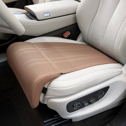 Car seat with a brown massage cushion on a beige interior.