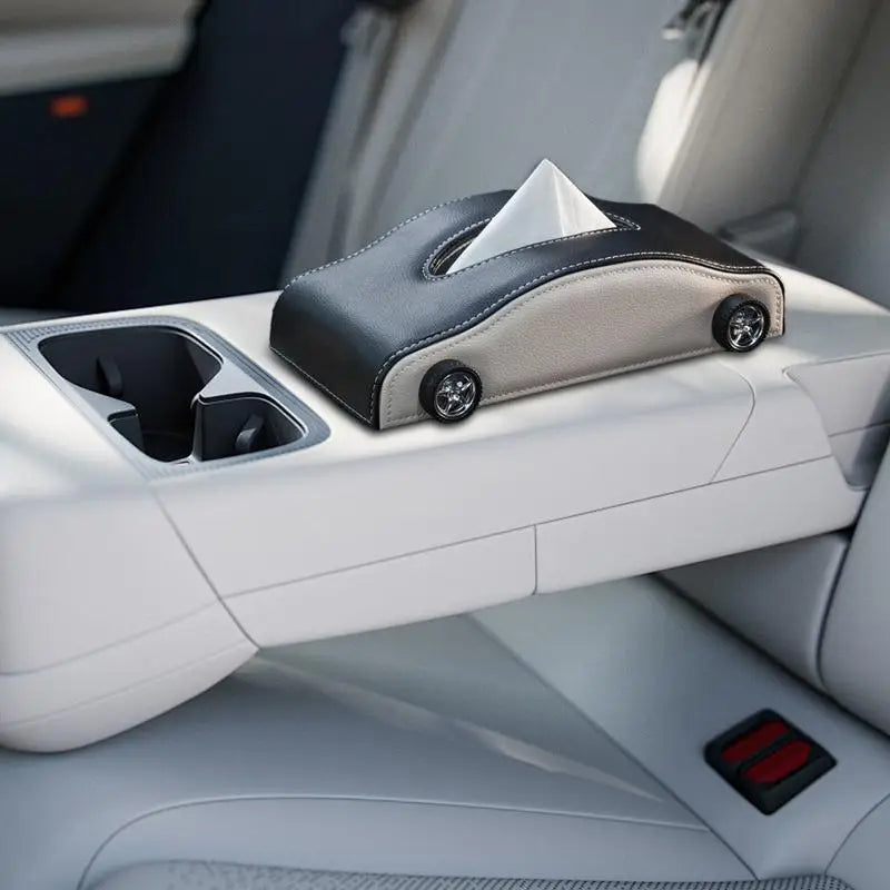 Car tissue holder with tissues on a car's console tray.