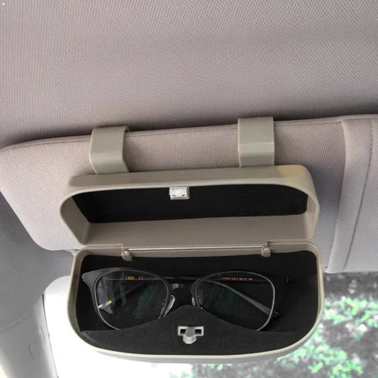 Car visor with sunglasses holder containing sunglasses