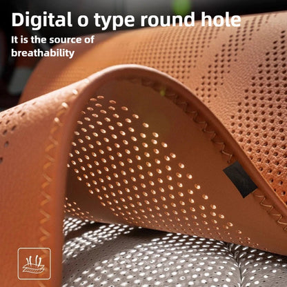 Close-up of a brown sandal with perforated design on a gray surface.