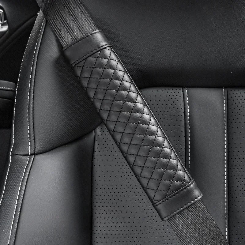 Close-up of a car seat with a quilted black seat belt.