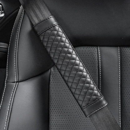 Close-up of a car seat with a quilted black seat belt.