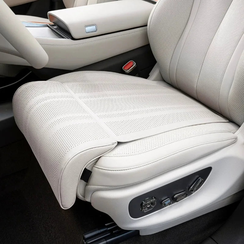Close-up of a car seat with massage and heating functions in a vehicle interior.