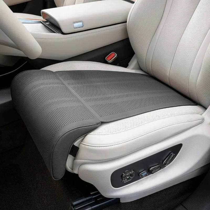 Gray car seat cover on a white car seat with visible stitching details.