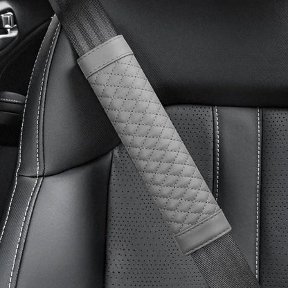 Gray quilted car seat belt cover on a car seat