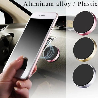 Phone holder with magnetic pads on a car dashboard