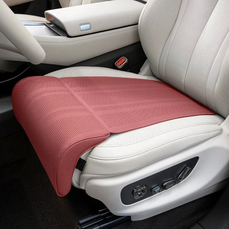 Red car seat cushion on a white car seat