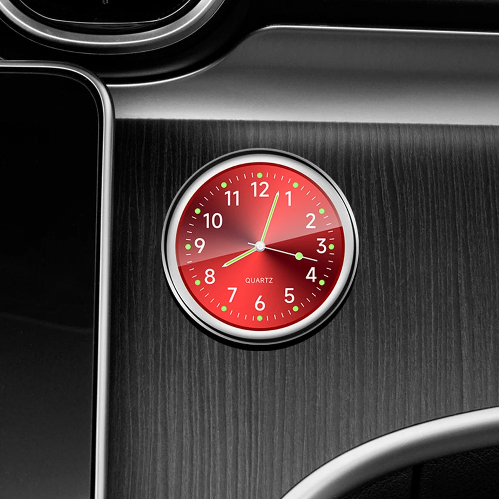 Red clock with silver frame on a dark metallic surface