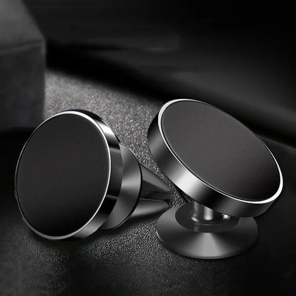 Two metallic phone holders on a dark textured surface